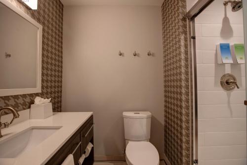 a bathroom with a toilet and a sink and a shower at Home2 Suites By Hilton Charlotte Uptown in Charlotte