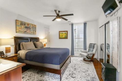 Lil Red Door Perfect 1BD in Bywater with Courtyard في نيو أورلينز: غرفة نوم بسرير ومروحة سقف