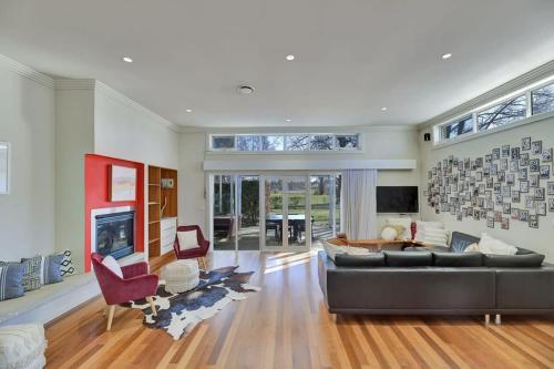 a large living room with a couch and a fireplace at Art House on Anson - Artistic Haven, Spa, Pets in Orange