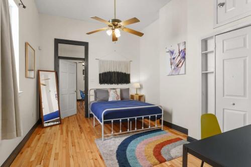 a bedroom with a blue bed and a ceiling fan at Gorgeous backyard Pool 2BD Midcity Retreat in New Orleans