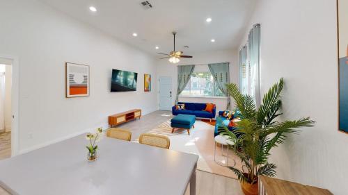 a living room with a couch and a table at Sunny 5Bed w Parking and direct Streetcar access in New Orleans