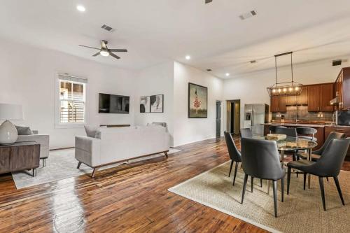 a living room with a couch and a table and chairs at 5Bed StreetCar Retreat w Outdoor Entertaining in New Orleans