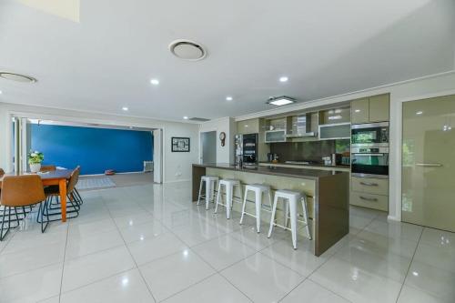 a large kitchen with a dining room and a table at Southlakes Haven - Lake Views, Pet Friendly in Dubbo