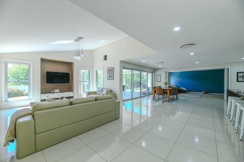 a living room with a couch and a dining room at Southlakes Haven - Lake Views, Pet Friendly in Dubbo