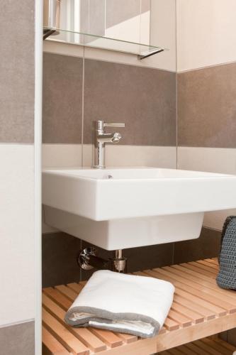 a bathroom with a white sink and a mirror at Palazzo Talenti 1907 in Trieste