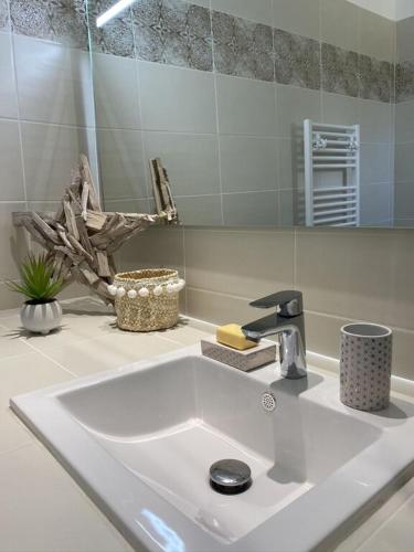 La salle de bains est pourvue d'un lavabo et d'un robinet. dans l'établissement Villa Piazzola, à Petreto-Bicchisano