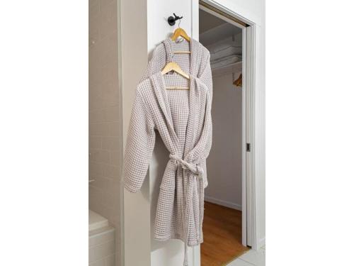a robe hanging on a door in a hallway at Chardonnay Chalet I Fireplace I Mountain View I TV in Invermere