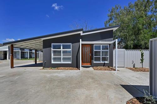 a house with a driveway in front of it at The Elm Apartments - The Orange Room in Orange