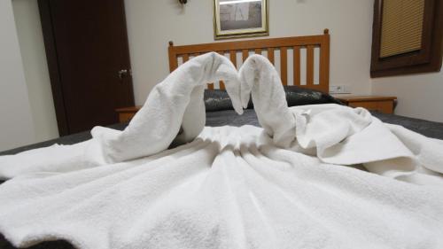 a pile of white towels on a bed at Hotel Ave Maria in Selcuk