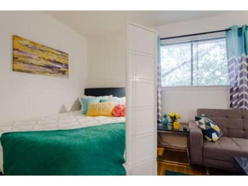 - une chambre avec un lit, un canapé et une fenêtre dans l'établissement Nomad Studio l 12-Min to DT l 5-Min to Domain l TV, à Austin