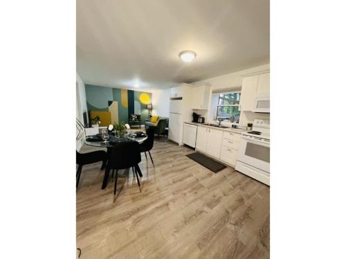 a kitchen and dining room with a table and chairs at The Artistry I Sled In & Sled Out I Riverside I TV in Bancroft