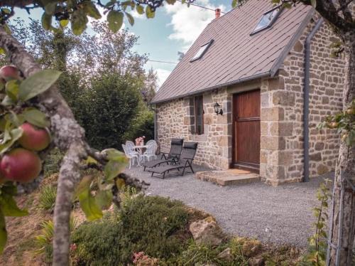 a stone house with a patio and a table and chairs at The Bakery in Beauficel