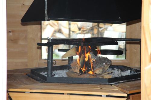 a stove with a fire inside of it at Norrängens Alpacka - Det lilla boutiquehotellet med en fluffy twist ! in Sala