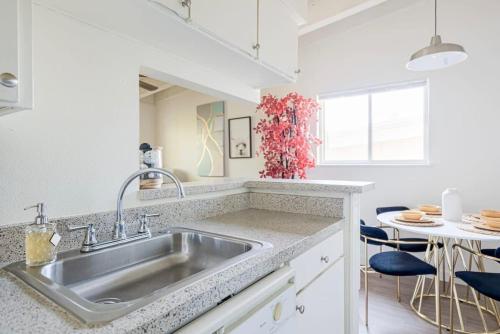 a kitchen with a sink and a table at The Modern I Sleep 5 I Close to Downtown I Roku TV in Austin