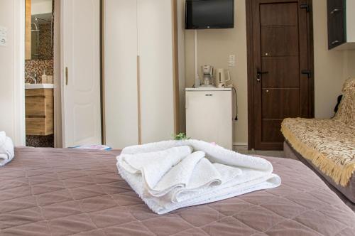 a room with a bed with white towels on it at Christina Rooms in Adamas