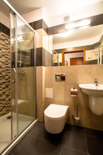 a bathroom with a toilet and a sink and a shower at Hotel ***NAT Świnoujście in Świnoujście