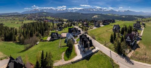 an aerial view of a village with mountains in the background at Silent Mountain in Bukowina Tatrzańska