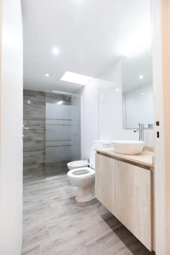 a bathroom with two sinks and a toilet and a shower at Wineland Logde East 2Pax. - by Inside in Ciudad Lujan de Cuyo