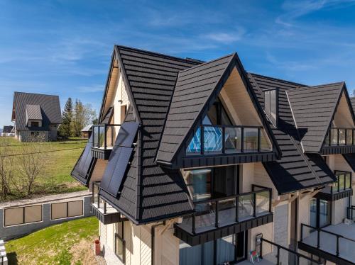 a house with a black roof at Silent Mountain in Bukowina Tatrzańska