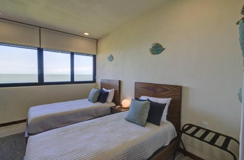 1 dormitorio con 2 camas y ventana en Beautiful Ocean View Penthouse With Private Pool -C301, en Isla Holbox