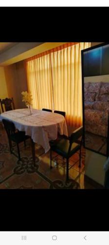 a dining room with a table and two chairs at Home Dreams Cusco in Cusco
