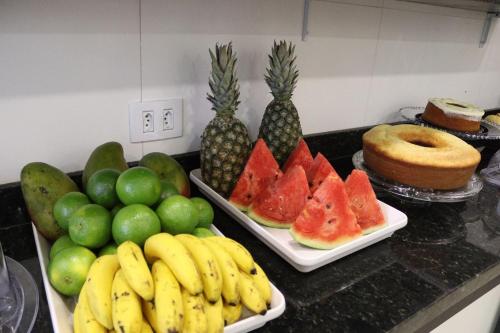 a table with fruits and vegetables on a counter at GM Hotel SP in Utinga