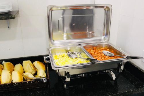 a tray of food on a counter with utensils at GM Hotel SP in Utinga