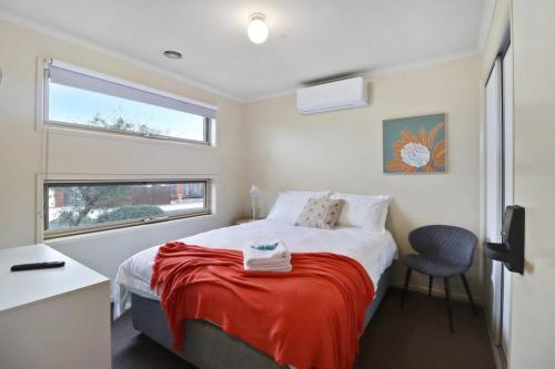 a small bedroom with a bed and a window at Reconnect on Daly I Epworth and Deakin in Geelong