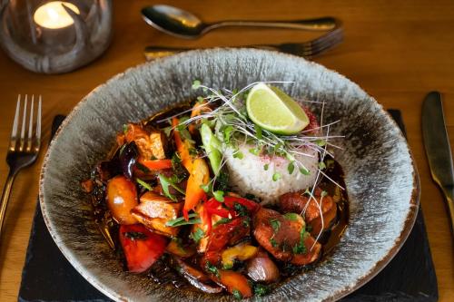 a bowl of food with rice and vegetables on a table at Boars Head Hotel in Carmarthen