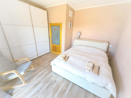 a small bedroom with a bed and a chair at Casa Bellavista in Montefegatesi