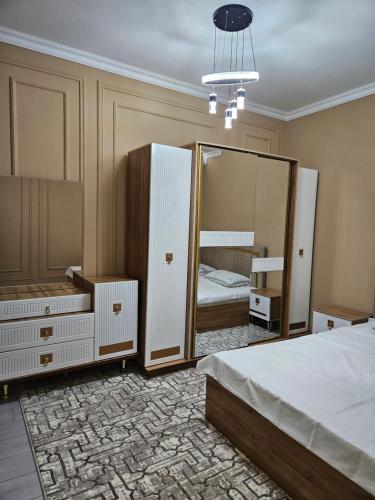 a bedroom with a bed and a large mirror at BONUSHKA 5* in Samarkand