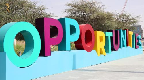 a sign for the supreme sign in front of a building at ZenDen 1BR -Serene Zen-Inspired Stay in Oasis Masdar, Near Masdar Park in Abu Dhabi