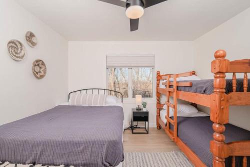 a bedroom with a wooden bunk bed and a window at Sunset Retreat Lakeside Vacation Home 