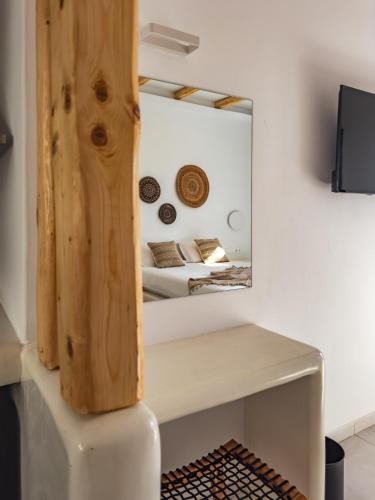 a room with a table and a mirror at Alonia Suites in Naousa