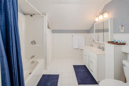 a bathroom with a tub and a toilet and a sink at Home Away from Home off College Avenue in Appleton