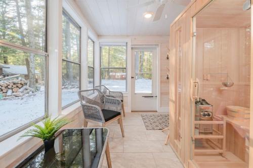 a home with a porch with a bench and windows at Cozy Cabin w Fireplace and Sauna in Mountain