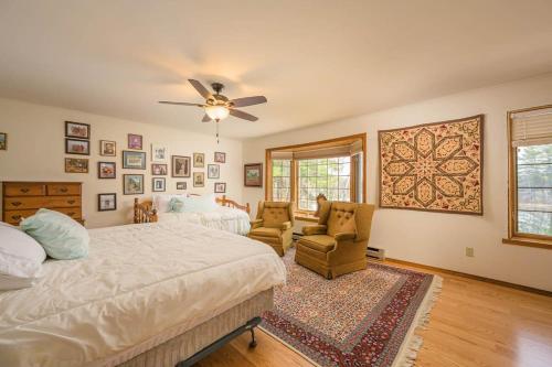 a bedroom with a bed and a ceiling fan at Lake House Vacation Sleeps 12 Private Dock in Waupaca