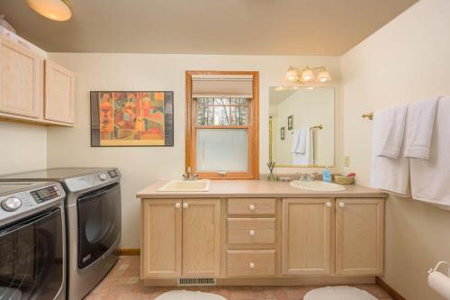 a kitchen with a sink and a dishwasher at Lake House Vacation Sleeps 12 Private Dock in Waupaca