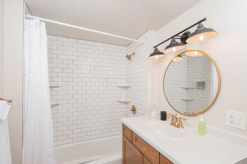 bagno bianco con lavandino e specchio di Brick House Charm 4 br 3 bath ad Appleton
