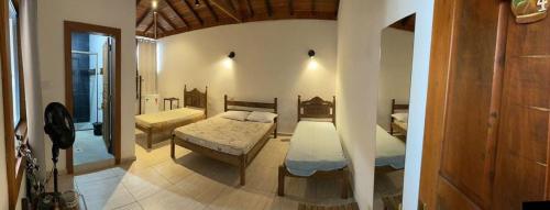 a bedroom with two beds in a room at Suítes Encanto de Minas in Tiradentes