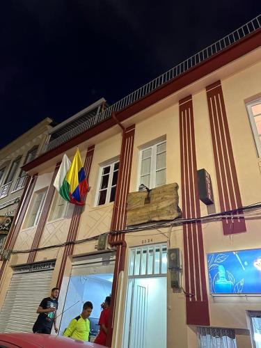 a group of people standing outside of a building with a kite at Boutique del cafe in Manizales