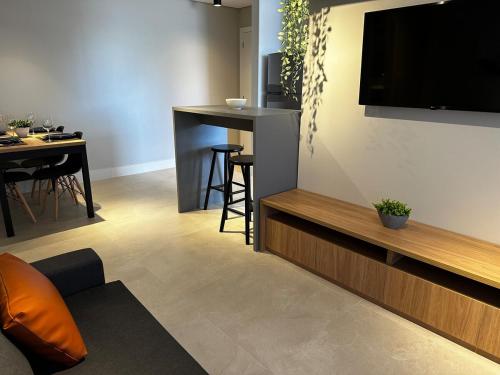 a living room with a flat screen tv on a wall at PARK SUL - Edifício Essence - 6 in Brasilia