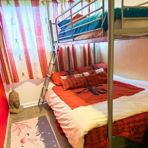 a bedroom with a bunk bed with a bedspread on it at Oriental Belle Aire in Hemsby