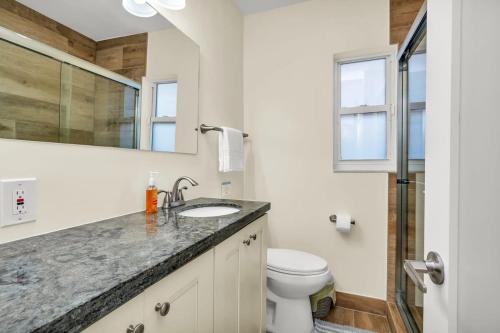 a bathroom with a sink and a toilet at Charming Multi Family 3 Bedroom with a Pool - Great Location in Dania Beach