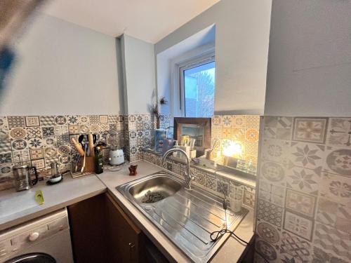 a kitchen with a sink and a window at Cozymodrenroom in Brighton & Hove