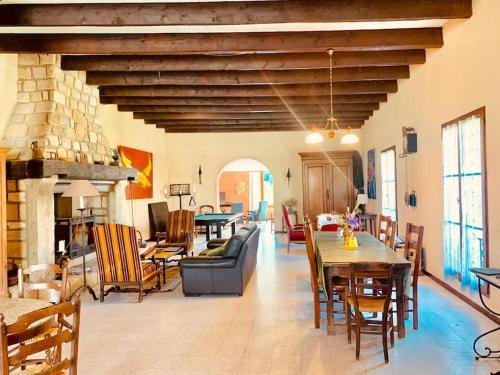 sala de estar con sofá, mesa y sillas en Maison en Provence au bord de la rivière, en Montfrin