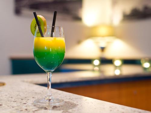 a drink in a glass sitting on top of a counter at ACHAT Hotel Monheim am Rhein in Monheim