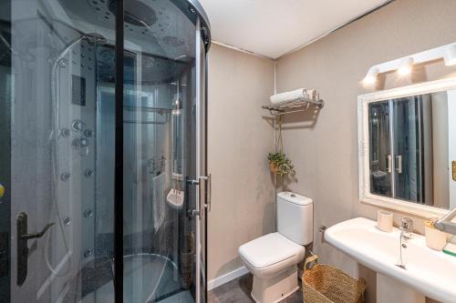 a bathroom with a shower and a toilet and a sink at La Cala golf and Sun apartment in Mijas