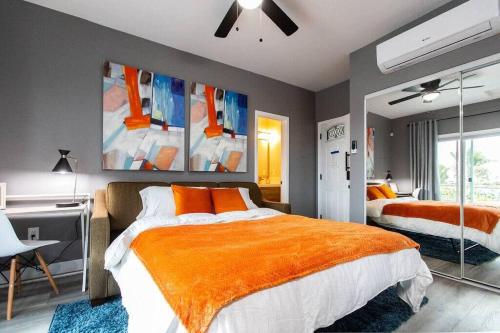 a bedroom with two beds and an orange blanket at Studio - Balcony - A C - Dogs Parks Restaurants in San Diego
