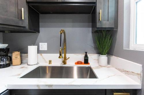 a kitchen counter with a sink in a kitchen at Studio - Balcony - A C - Dogs Parks Restaurants in San Diego